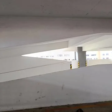 Curved concrete ramp inside multi-level parking garage Stock Photos