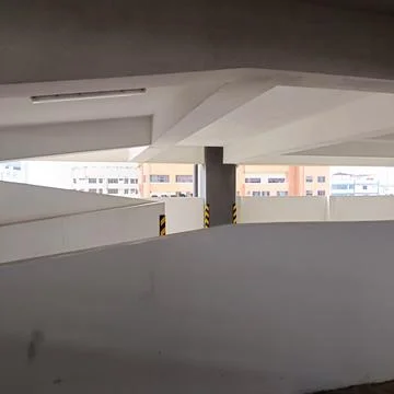 Curved concrete ramp inside multi-level parking garage Stock Photos