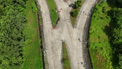 Curved Concrete Road Intersection with Forest and Drainage Ditches Vídeo Stock 347527933