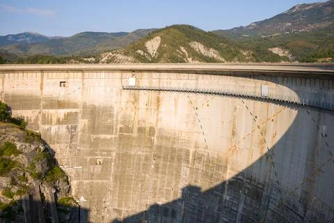 Curved dam wall with dramatic shadow pattern Stock Photos