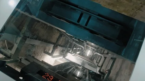 Curved elevator shaft. A downward elevator with a transparent glass top through Video stock 106468782