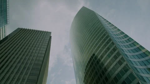 Curved Glass Facade, Dramatic Low Angle Against Cloudy Sky Stock Footage 345871892