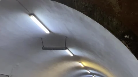 Curved illuminated tunnel ceiling with fluorescent lights Video stock 344038246