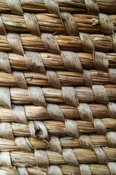 Curved lines pattern in a straw basket background. Stock Photos