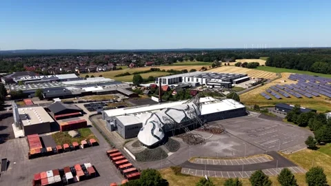 Curved lizard shaped building with sculptural facade of Wiesmann sits among Stock Footage 341652617