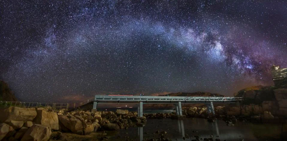 Curved Milky Way over a bridge Stock Photos