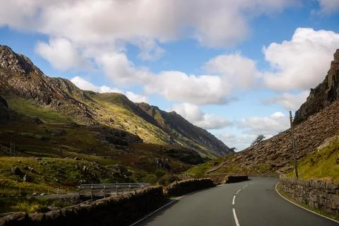 Curved mountain road through dramatic valley in Snowdonia, Wales Stock Photos