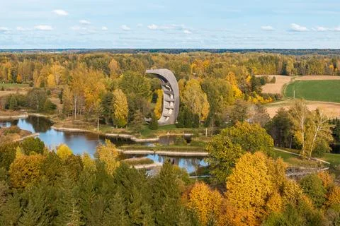 Curved Observation Tower Amidst Vibrant Autumn Foliage Near Water Stock Photos