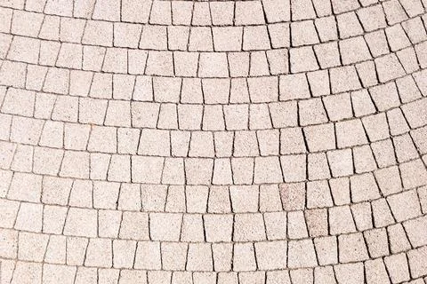 Curved pattern of light-colored cobblestone pavement Stock Photos