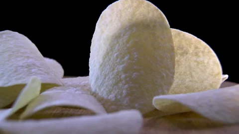Curved Potato Crisps Rotating, Low-Angle View of Their Geometry Stock Footage 345426746