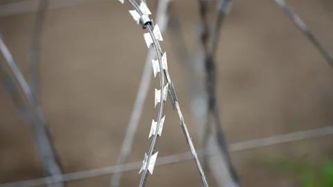 Curved Razor Wire Edge Isolated Over Neutral Ground, Close-Up Stock-Footage 344119136