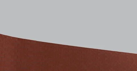 Curved red brick wall on a plain gray background representing structure, si.. 스톡 일러스트