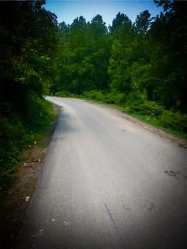Curved road between mountains Stock Photos