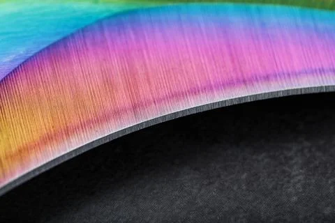 The curved sharp blade of the Kerambit Dagger is a gradient rainbow color on  스톡 사진