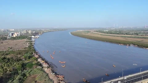 Curved Tapi River aerial landscape with boats and natural shoreline in Surat Stock Footage 332670650