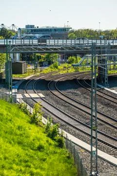 Curved train tracks beneath elevated roadway. Stock Photos