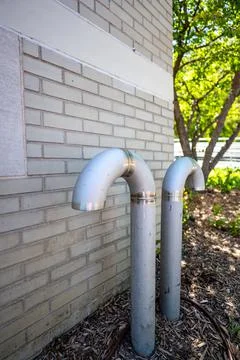 Curved ventilation pipe used to equalize pressure and provide air to an Stock Photos