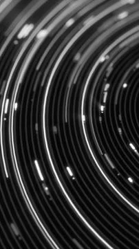 Curved white light trails sweep across a black background, forming a monoch.. Stock Illustration