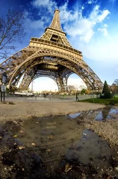 Curves of the Eiffel Tower under blue sky at shiny Winter mornin Stock Photos