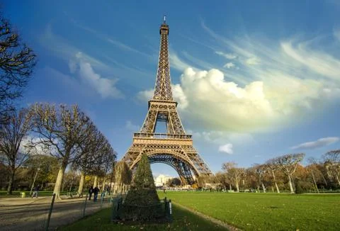 Curves of the Eiffel Tower under blue sky at shiny Winter mornin Stock Photos