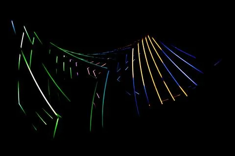 Curving abstract composition of multicolored glowing lines Stock Photos