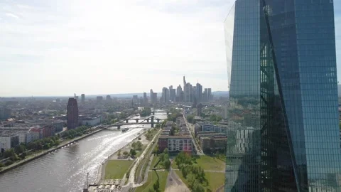 Curving orbit beside ECB tower with skyline and river Stock Footage 331874323