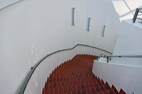 Curving red brick steps with white rounded concrete walls Stock Photos