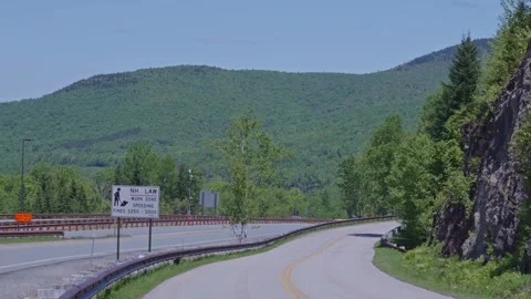 Curving road with work zone sign in White Mountain National Forest, United Stock Footage 337536833