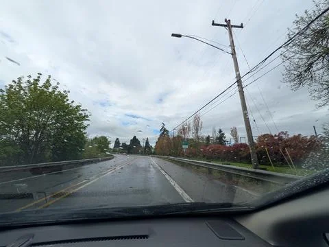 Curving roadway bordered by tall trees passes the "Entering Corvallis Stock Photos