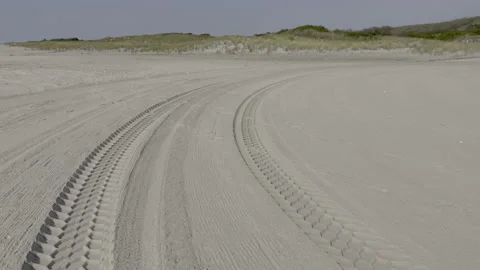 Curving tire tracks on the beach. Jacob Riis Park.Queens. New York Stock Footage 220732971