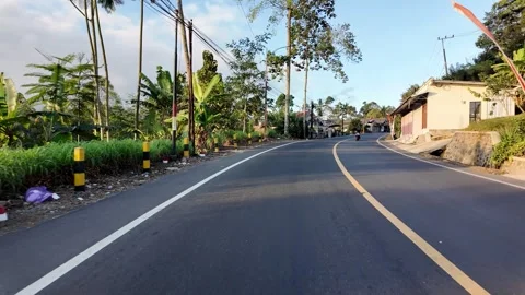 Curving Tropical Road Through Quiet Village Landscape At Ground Level Stock Footage 345143392