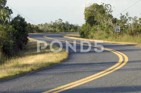 Curving winding road 35 mph speed limit Stock Photos