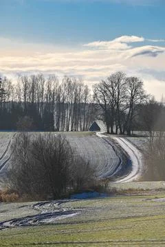Curving Winter Path Leading to a Distant Barn in Latvia Stock Photos