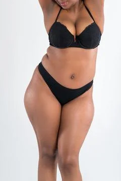 Curvy busty plus size model in push up bra on gray studio background, overwei Stock Photos