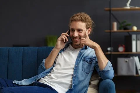 Curvy guy using smartphone and smiling. Happy man using mobile phone apps Stock Photos