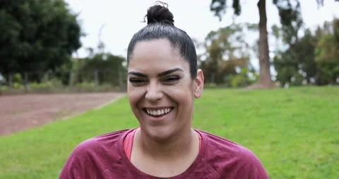 Curvy woman smiling in camera while doing jogging routine outdoor Видео 153404914