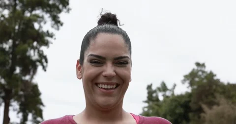 Curvy woman smiling in camera while doing jogging routine outdoor Stock Footage 153462074