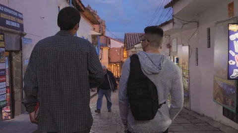 CUSCO, PERU - APRIL 2018: Two men walking and talking in a street in Cusco Stock Footage 91401091