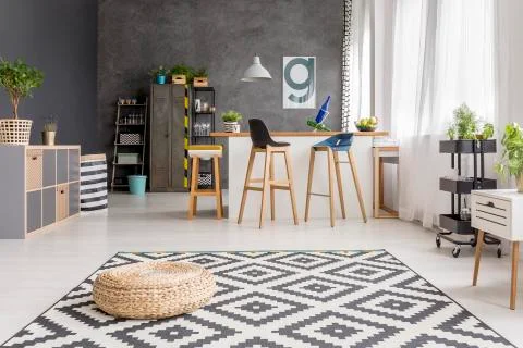 Cushion lying on patterned rug Stock Photos