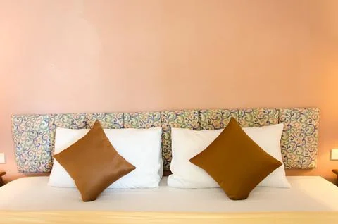 Cushions on bed Stock Photos