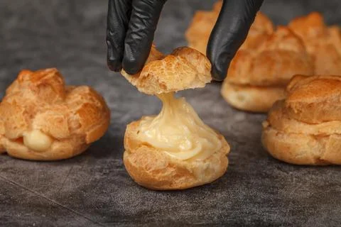 Custard-filled profiteroles ready to serve. 스톡 사진