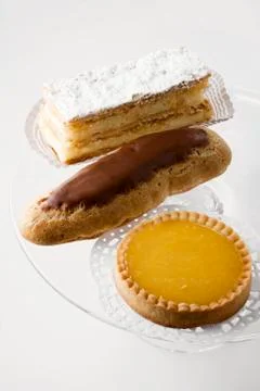 Custard slice, chocolate eclair and lemon tart Stock-Fotos