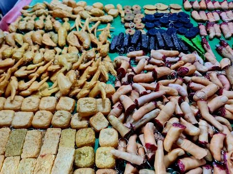 Custom Artisan Novelty Keychains: Fried Tofu, Chicken Wings, and Gory Fingers Stock Photos