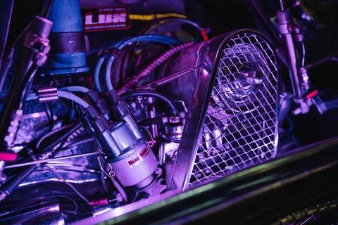Custom car engine bay with intricate wiring and neon lighting Stock Photos