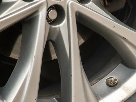 A custom car wheel missing a valve stem cap Stock Photos