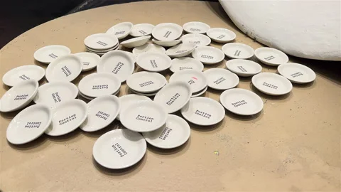 Custom designed Cup coasters storefront display - 4K Prores 422 HQ Stock Footage 233128859