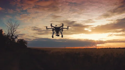 Custom drone hexacopter flying in the sky at sunset Vídeo Stock 64077660