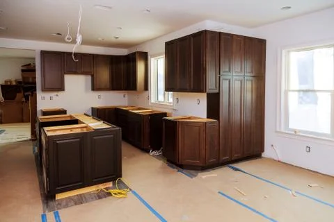 Custom kitchen cabinets of installation base for island in center Stock Photos