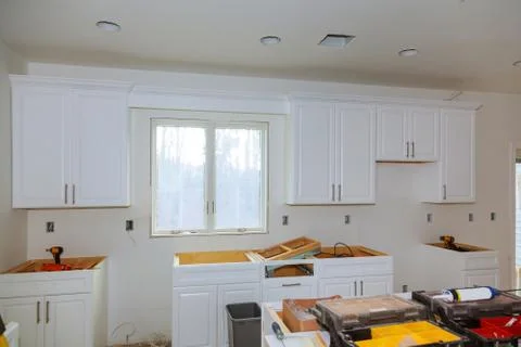 Custom kitchen cabinets of installation base for island in center Stock Photos