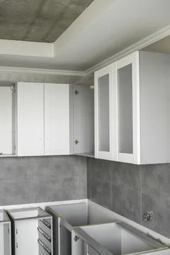 Custom kitchen cabinets installation with a white furniture facades mdf. Gray Stock Photos